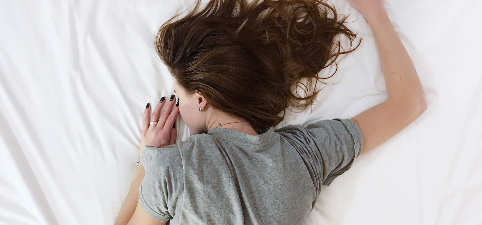 woman face down on bed